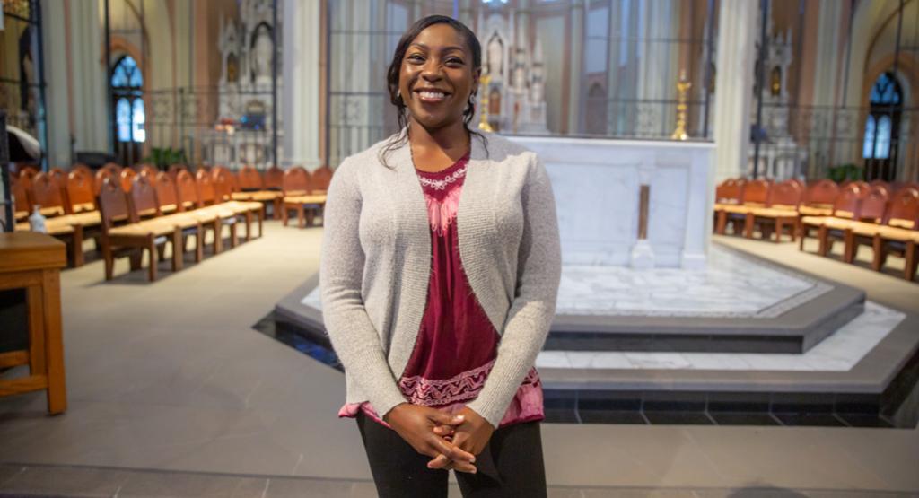 St. John's Sacristan Vivian Amu posed for a photograph inside the church.