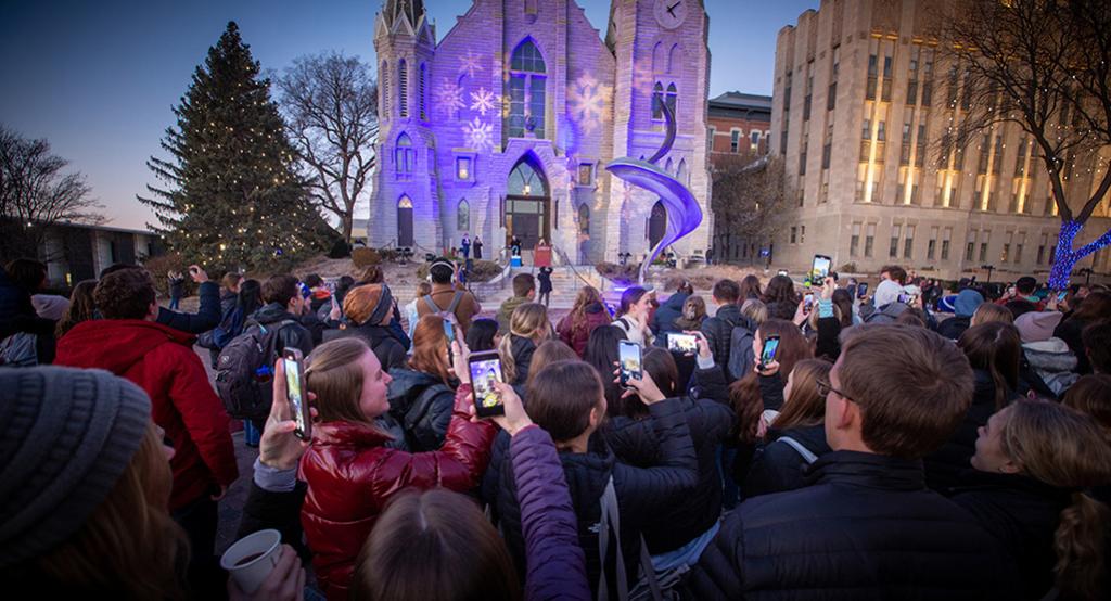 An image of students in front of St. John's during the Christmas at Creighton lighting ceremony.