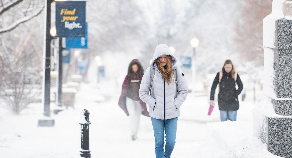 Students walk through snow on campus