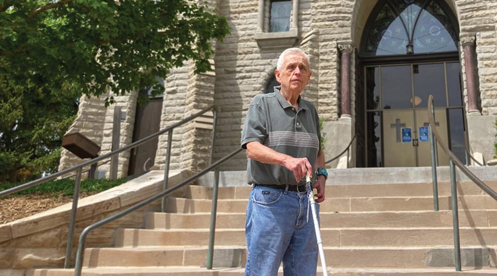 Father Larry Gillick in front of St. John's Church.