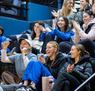 Students cheer together while at a watch party