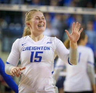 A volleyball player smiles