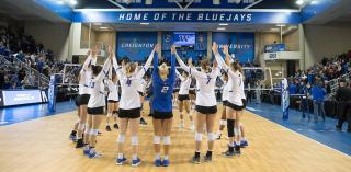 Creighton Volleyball team in a circle.