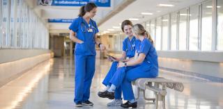 Nurses talking on the clinic floor.