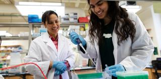 Professor and student doing lab work.