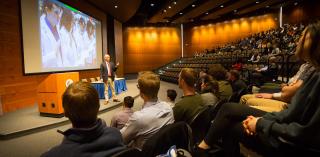 A professor gives a presentation in the Hixson-Lied Auditorium.