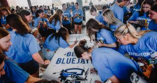Students signing a banner