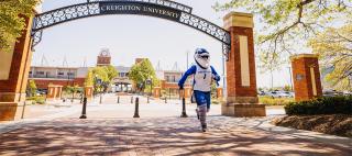 Billy Bluejay under Creighton arch