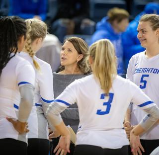 Coach Booth coaching players at a game.