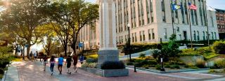 Students walking by Creighton Hall on campus
