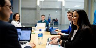 Business students talking at a table.