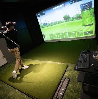 Golf simulator inside the McGraw Family Indoor Golf Center