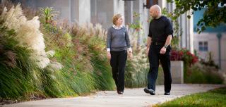 Jesuit and staff member walking together