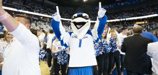 Billy Bluejay holding up fingers cheering for Creighton University