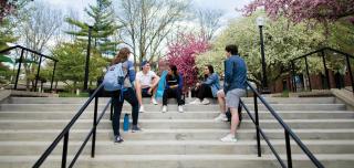 Creighton University students sitting on steps talking