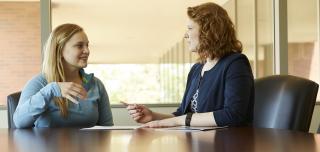 Women mentoring a female recent graduate