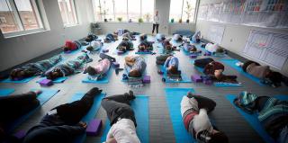 A group of students lay on yoga mats