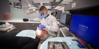 Dental student providing care to a patient