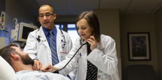 School of Medicine student uses stethoscope on patient