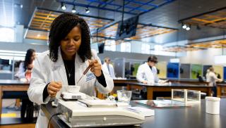 Female student conducting research in a lab.