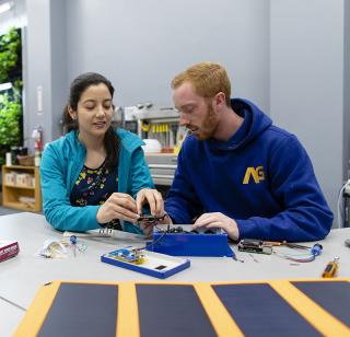One male and one female student work on a technology project
