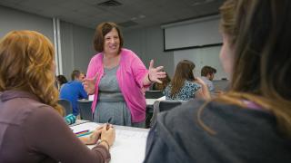 Carol Zuegner teaches in a classroom.