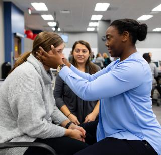 Occupational therapy student works with a patient