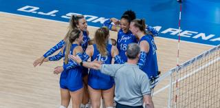 Volleyball players in team huddle