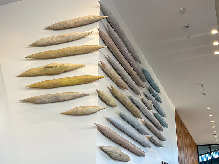 Cindy Weil, BA&rsquo;86, assembled and painted 28 wool-embroidered tube-like pieces