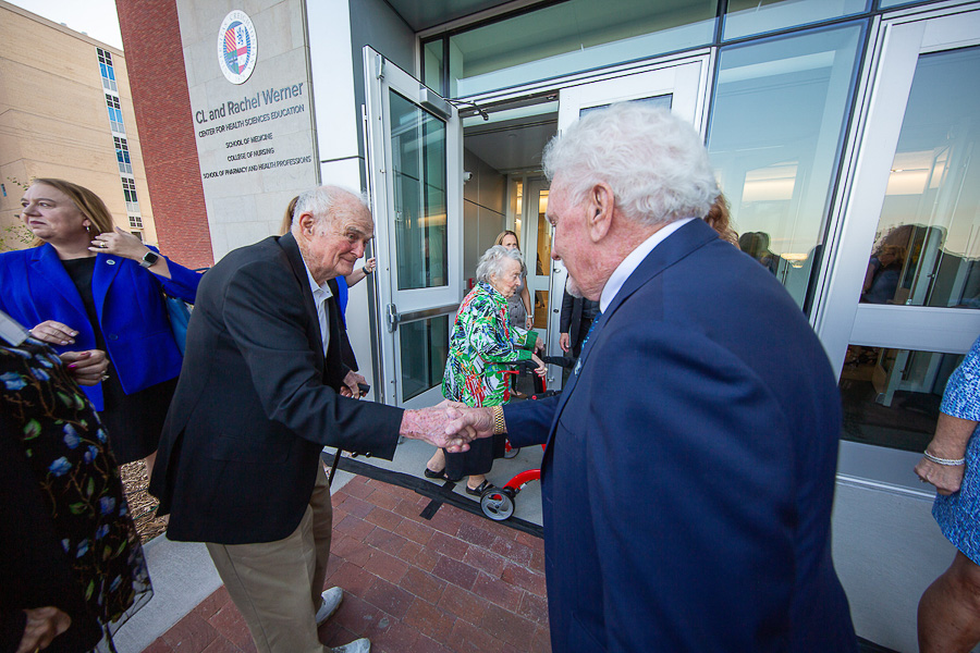 CL Werner, right, shakes hands with a man.