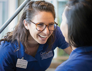 Two OT students talk and laugh.