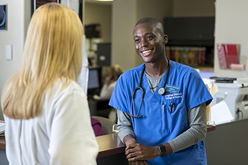 A nurse and physician have a conversation.