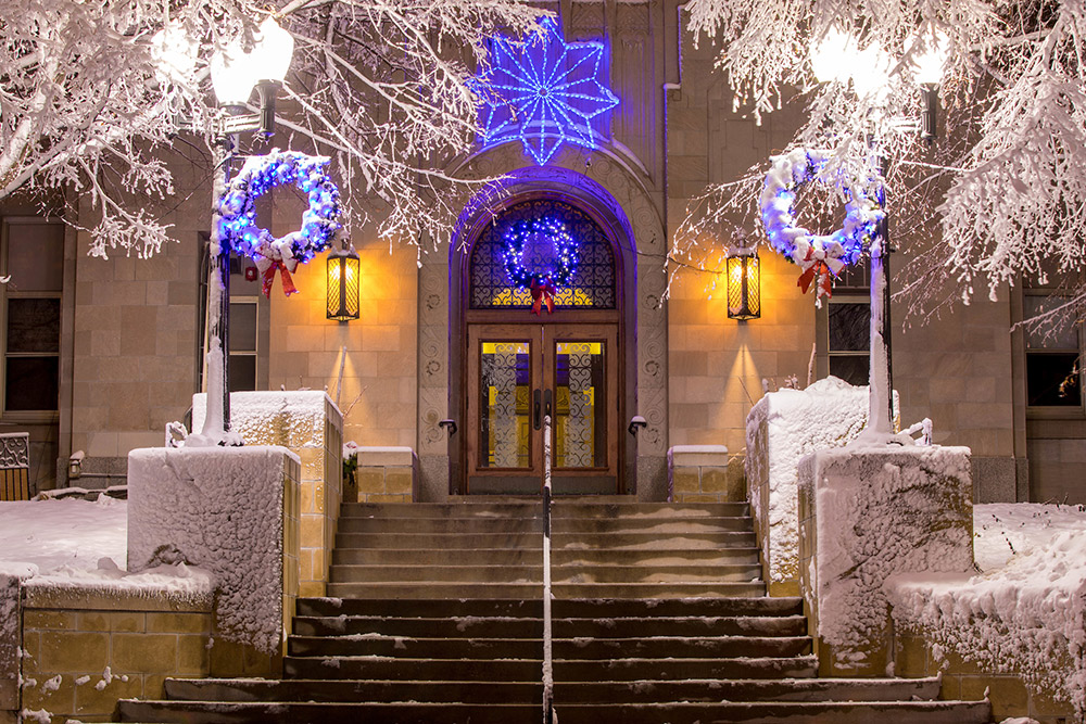 A snowy Christmas scene in front of Creighton Hall.