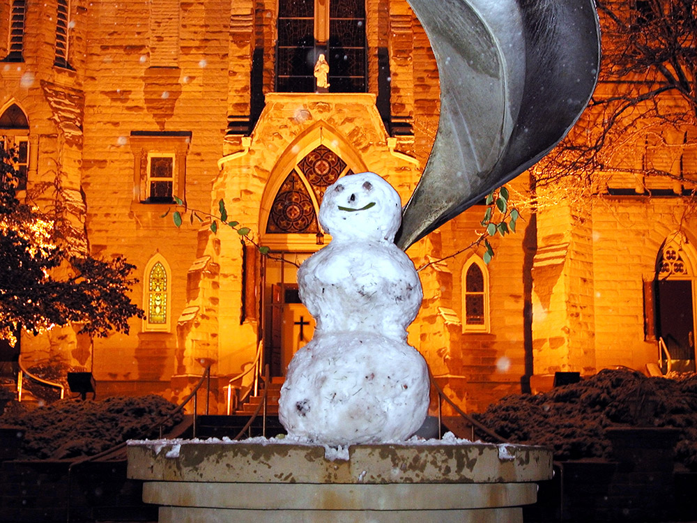 Someone built a snowman on the Eternal Flame sculpture/St. John's Fountain.