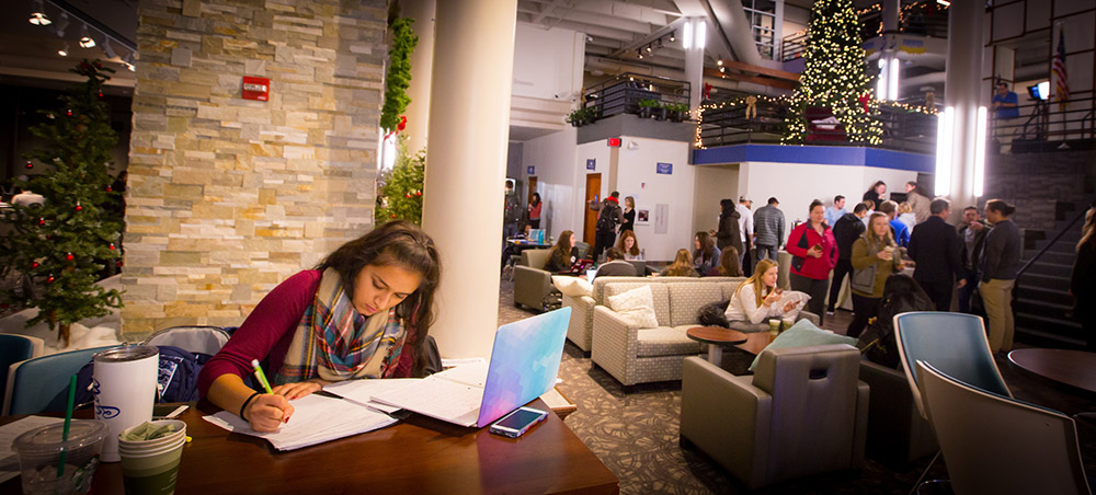 A student studies in Skutt during a Christmas party.